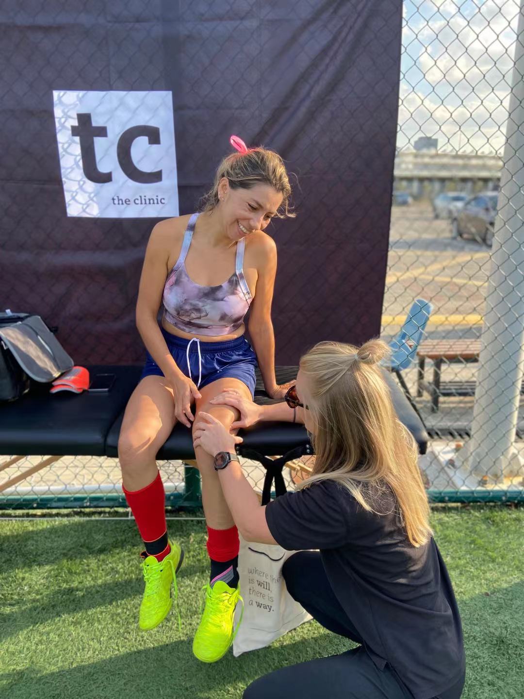 Acute knee assessment between matches — on-site treatment and taping.