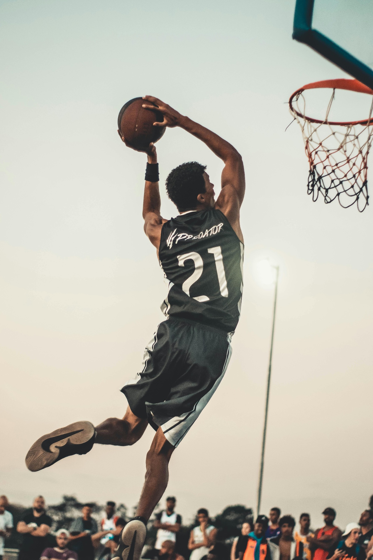 Athlete rising for a slam dunk — EXOS methodology bridges rehab and elite sports performance.